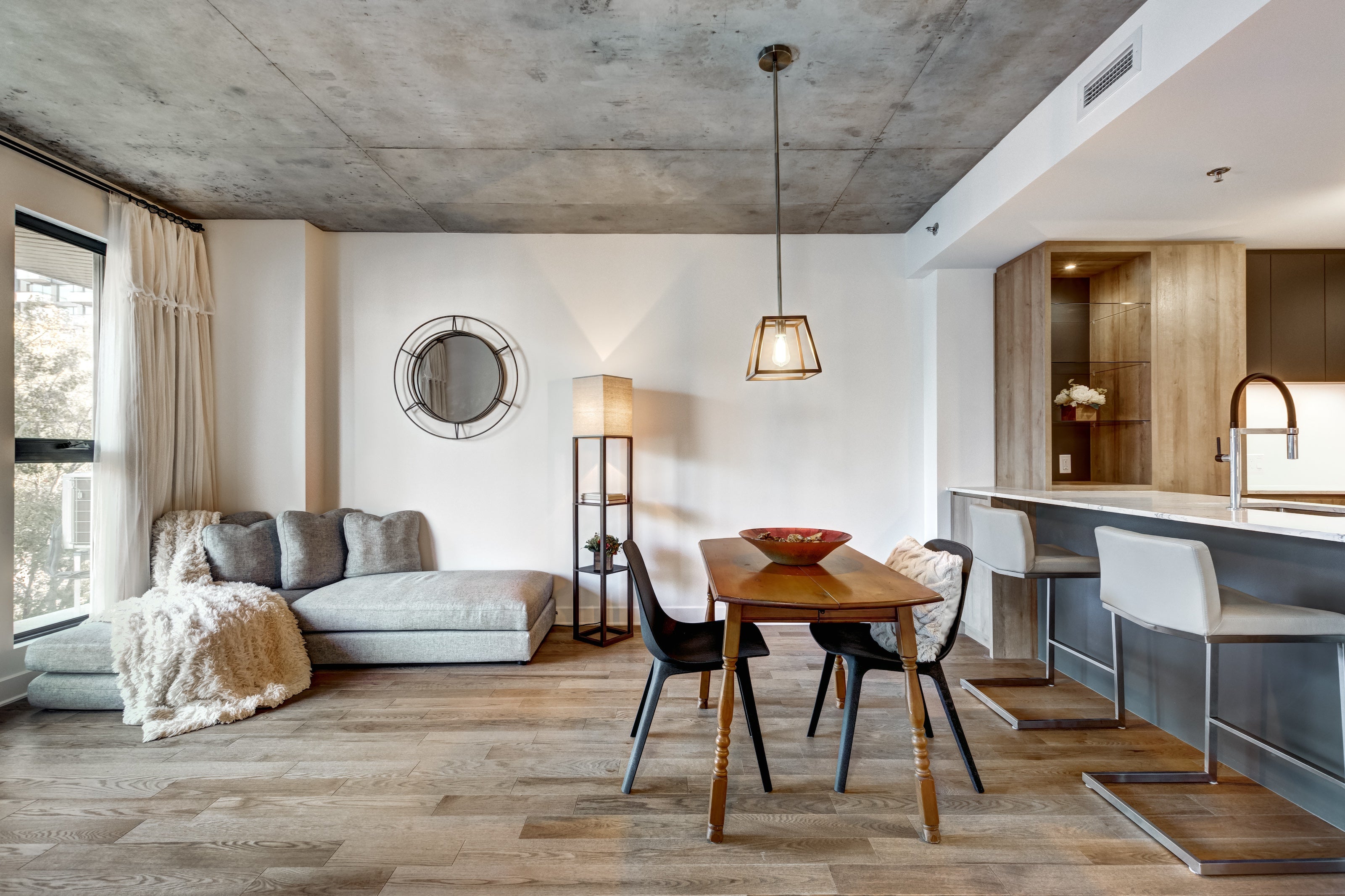 modern dining room with grey couch and wood table