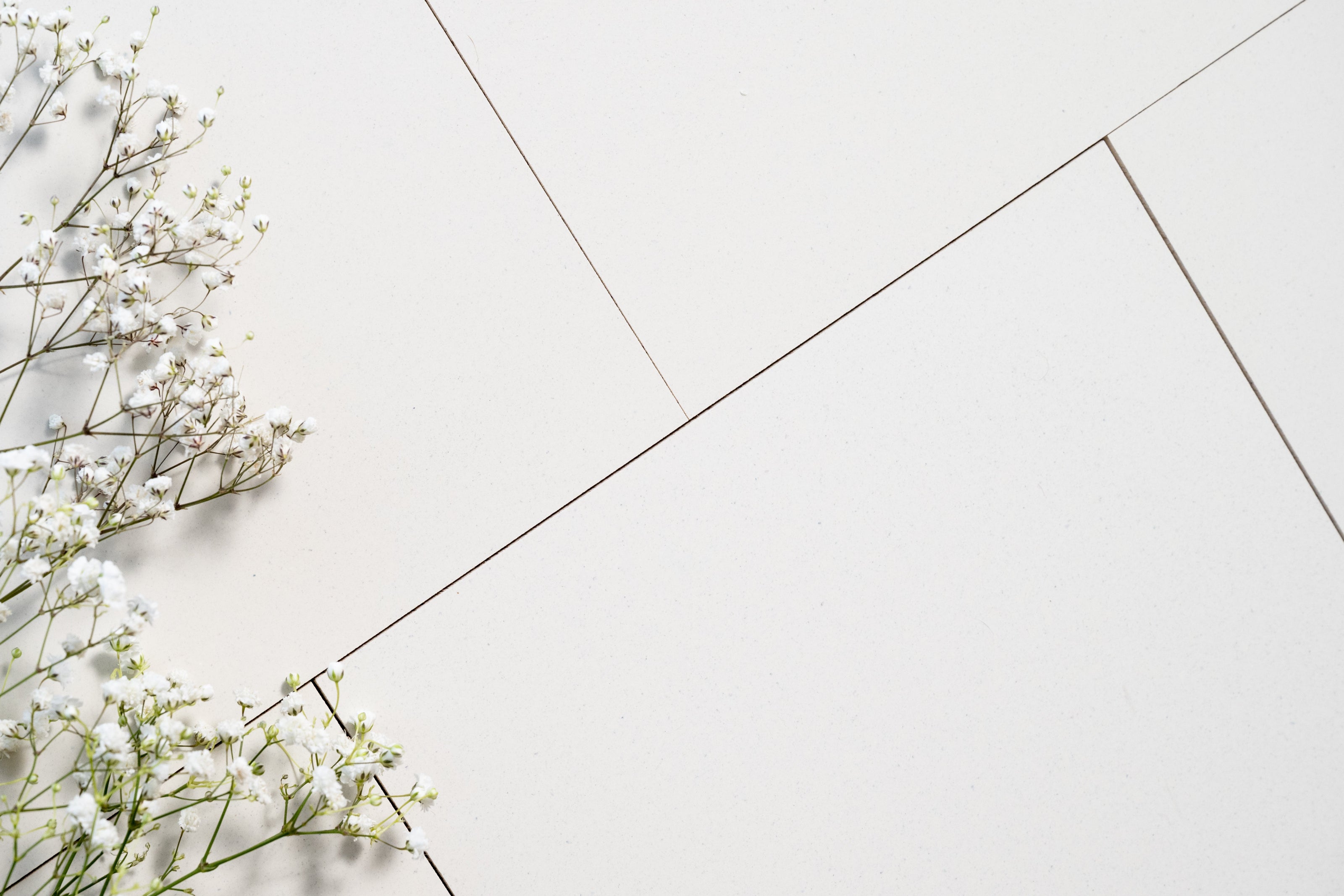 White flowers on a light gray tiled floor
